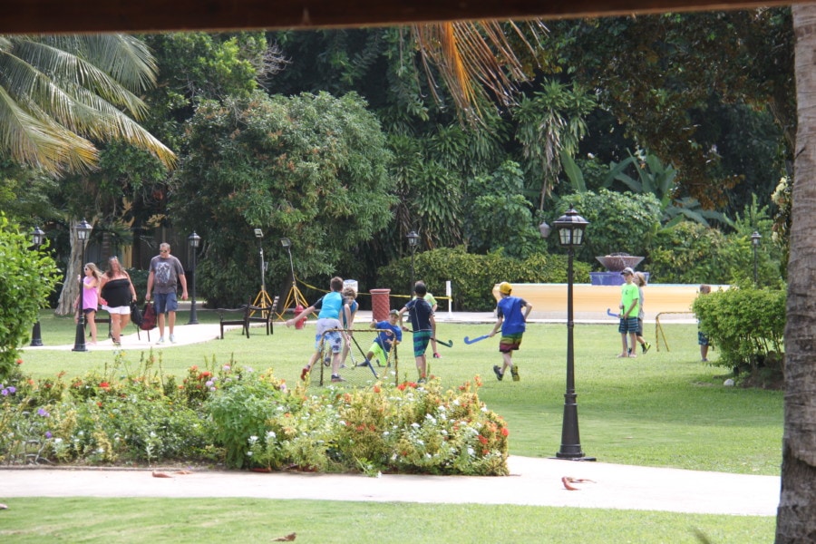 a bunch of kids playing field hockey on the lawn at Jewel Runaway Bay