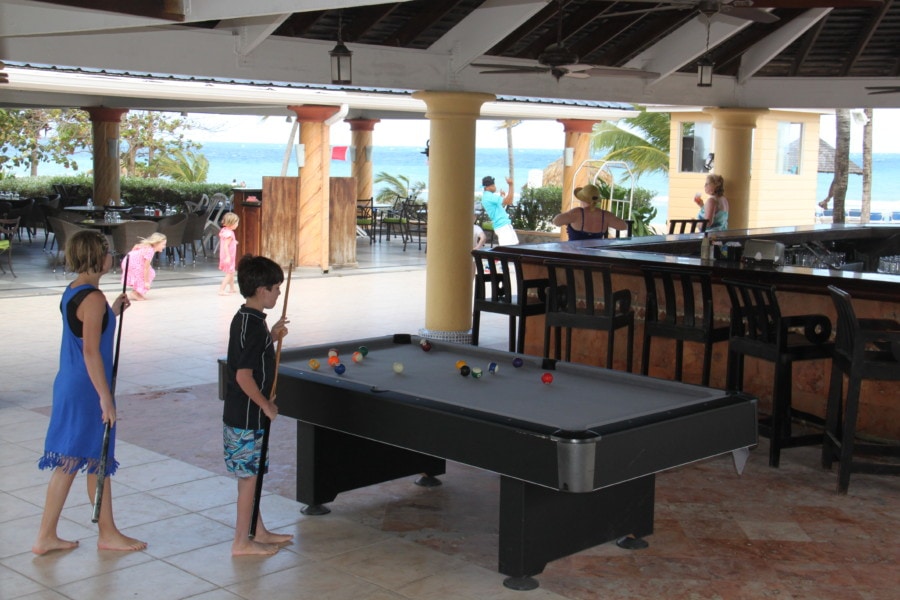 Caiden playing pool beside the bar at Jewel runaway Bay