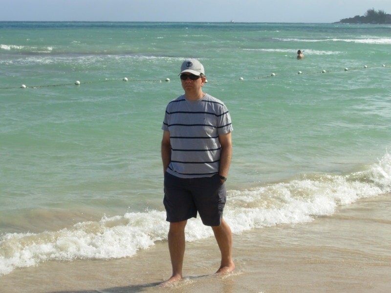 John walking on beach with hands in pockets at Jewel Runaway Bay Jamaica