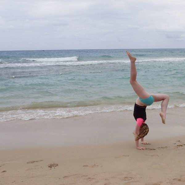 Sydney doing handstand on beach at Jewel Runaway Bay Jamaica