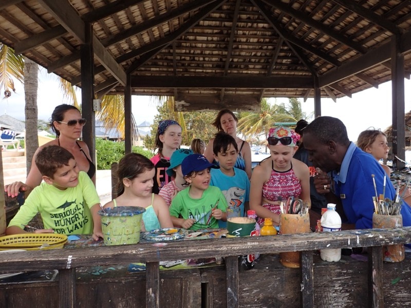 kids and adults around a wooden table making crafts with Clive at Jewel Runaway Bay Jamaica