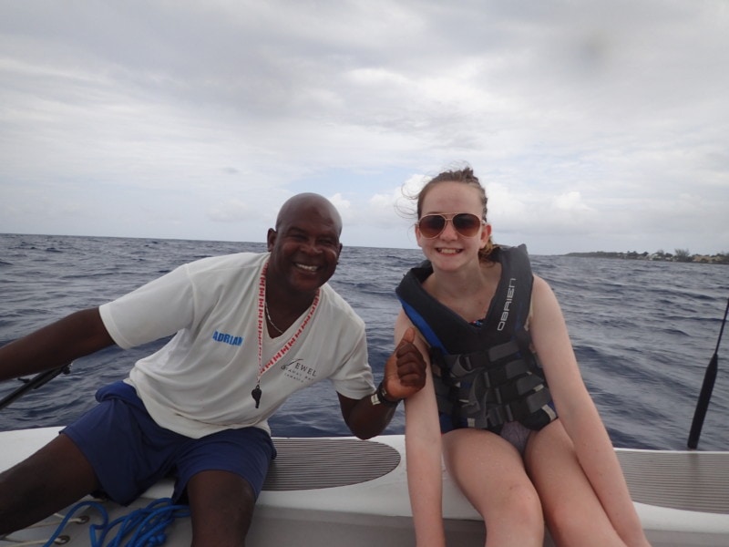 sydney and Andre on the side of a catamaran in the Caribbean sea at Jewel Runaway Bay