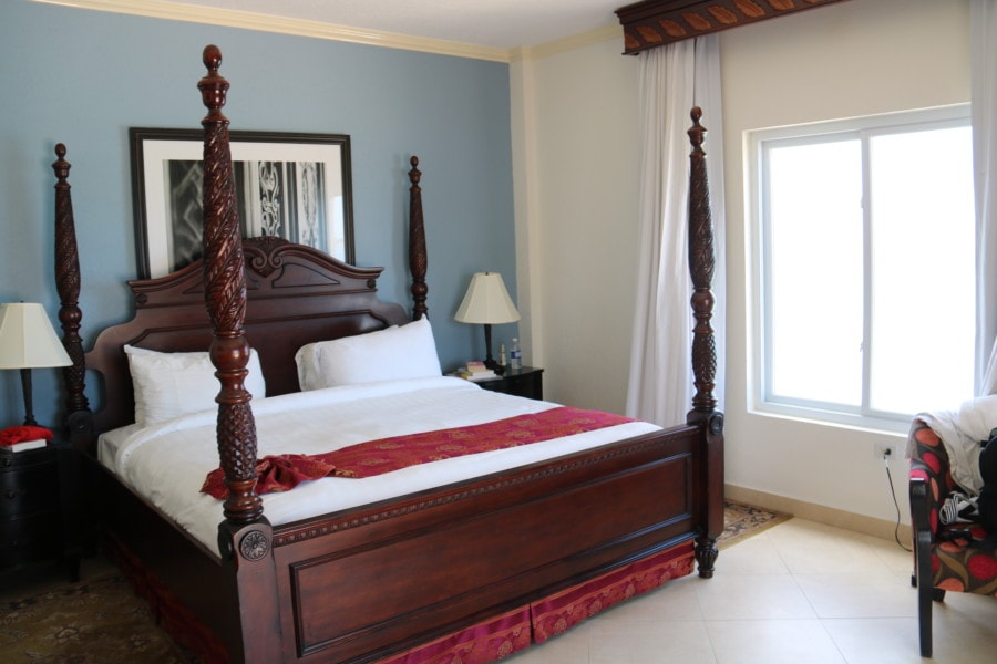 King size bed with tall corner posts in bedroom at Jewel Runaway Bay