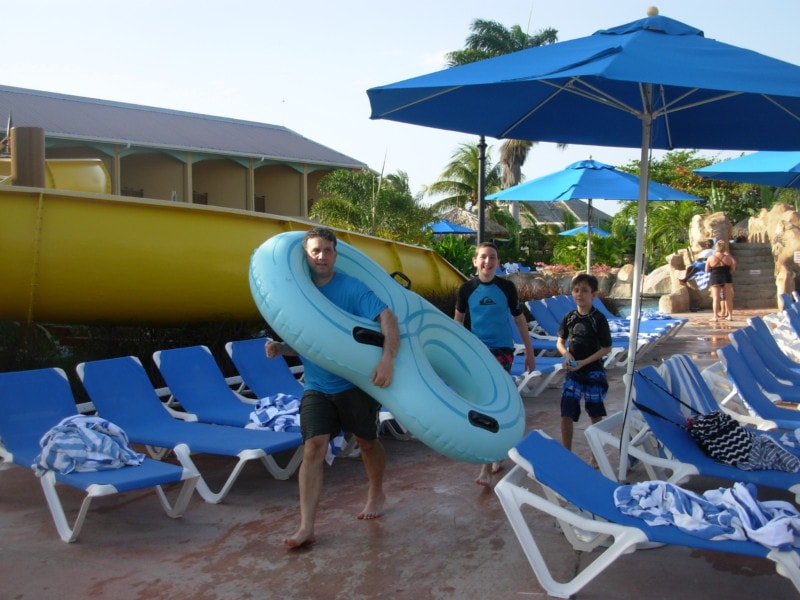 John carrying a double tube with boys following at Jewel Runaway Bay Jamaica