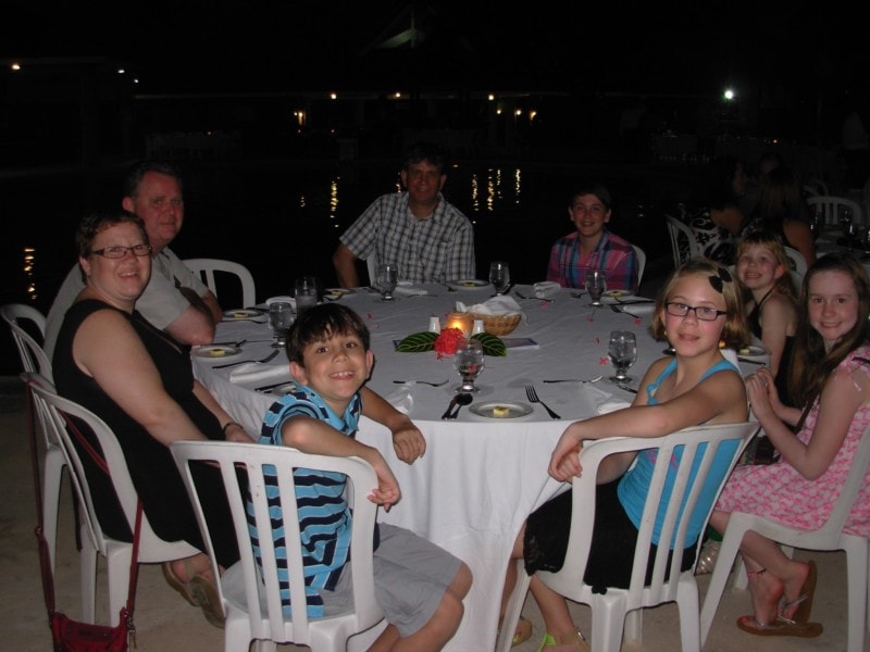Full family around a round table by the pool Jewel Runaway Bay