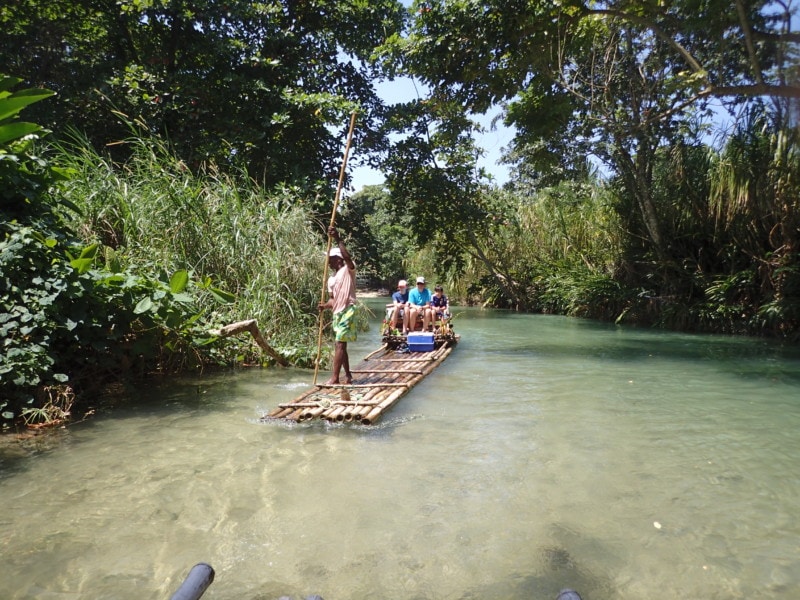 Family on a long bamboo raft Jamaica things to do