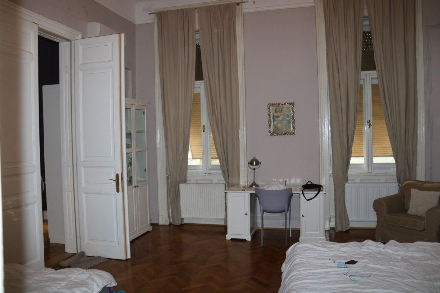 large bedroom with two windows and two double beds Budapest family apartment