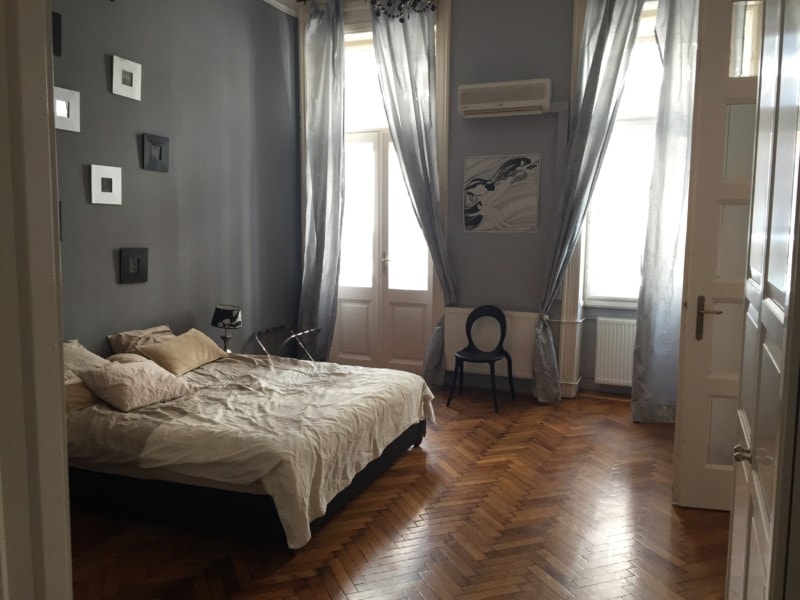 king size bed with doors to balcony in Budapest family apartment