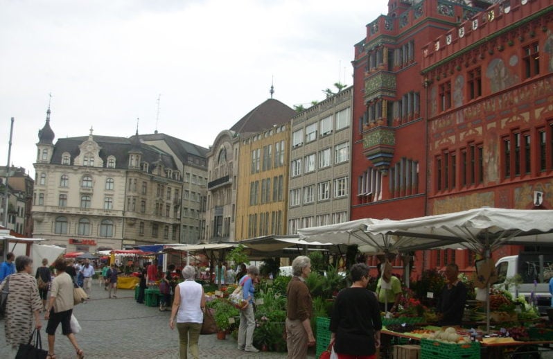 Local market with vegetable kiosks in front of Town Hall in Basel Switzerland