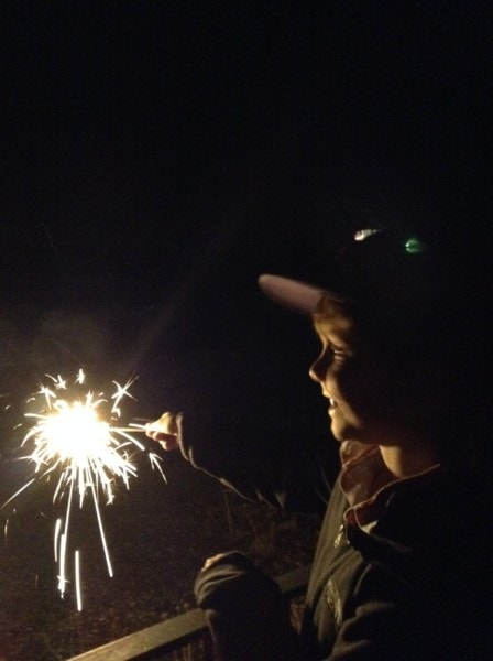 son with sparkler watching fireworks in Basel