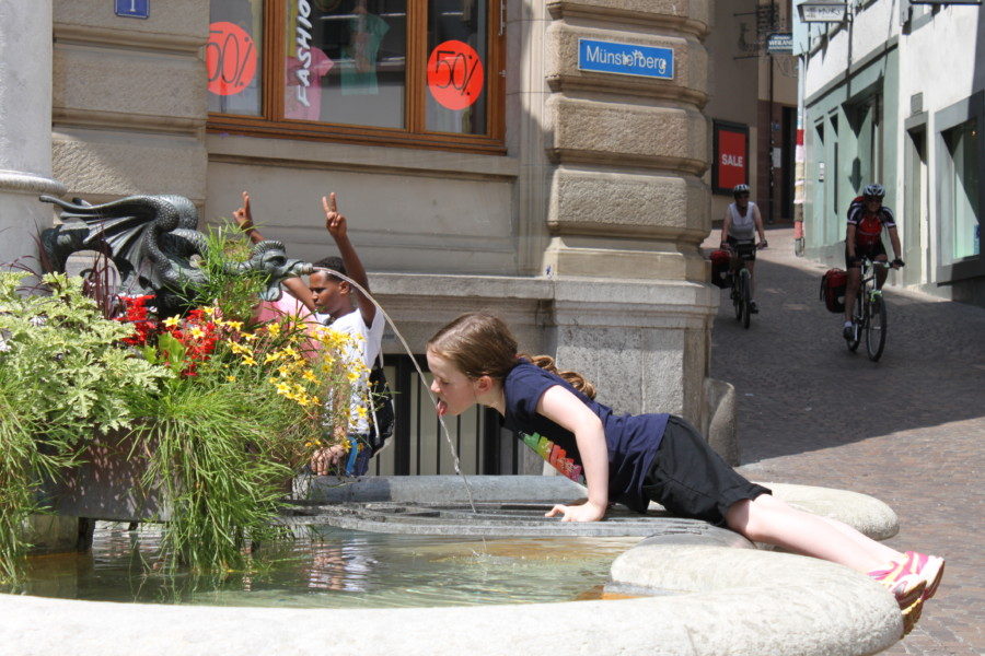 image of Sydney reaching to fountain in Basel for drink