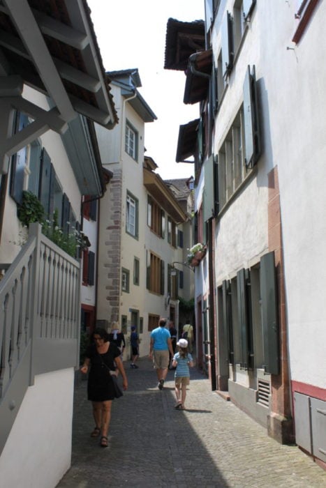 People walking in the narrow cobblestone streets of Basel Old Town is one of the best free things to do in Basel