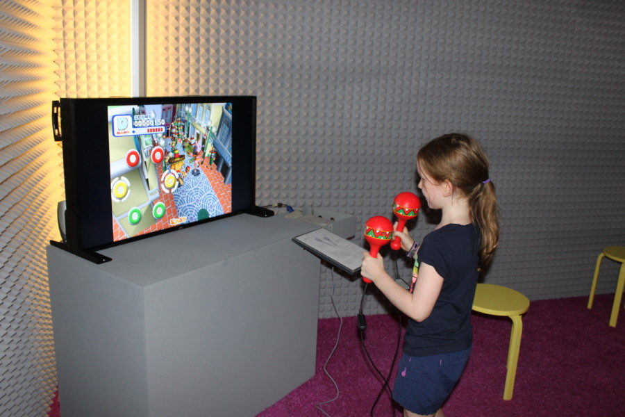 girl with maracas in hands playing video game