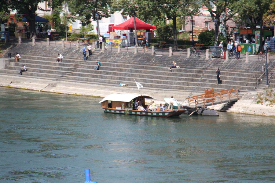 The ferry boat with half cover by the stairs on the Rhine is one of the most unique things to do in Basel