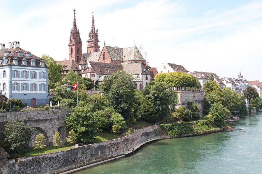 the edge of the Rhine River with red Munster imposing on the edge one of our favourite places to visit in Basel