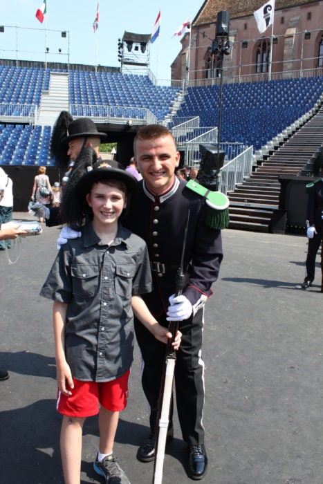 boy with soldier holding bayonette at Basel Tattoo