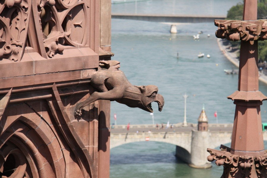 view from munster showing red gargoyle and bridge over the Rhine is one of the top things to do in Basel