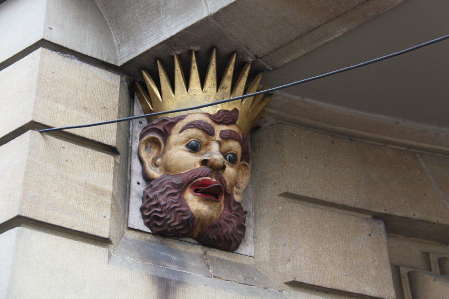 image of king head with tongue sticking out on corner of building in Basel