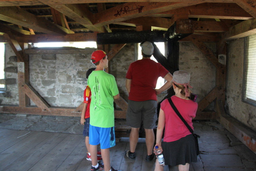 family looking at steel structures inside brick tower of wall Lucerne