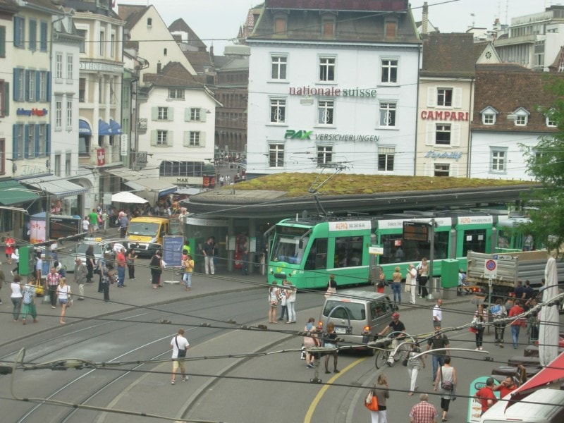 Basel green tram in central hub area in Basel City Guide for tourists
