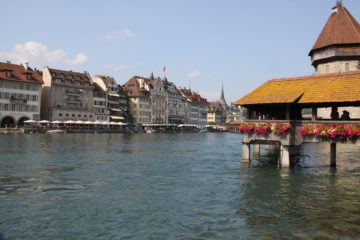 chapel bridge with flowers hanging outside during one day in Lucerne