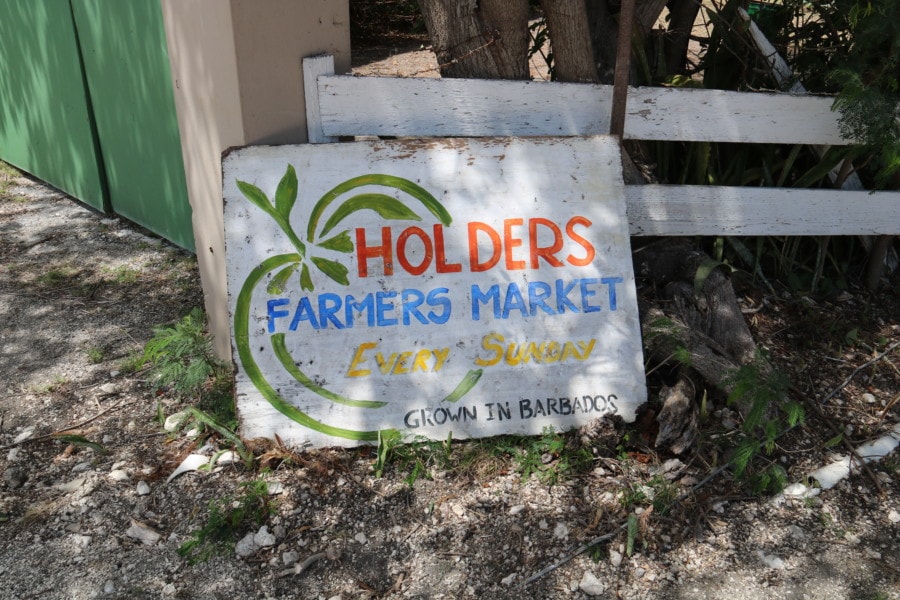 Old sign on ground saying Holders farmers market which is Barbados attraction