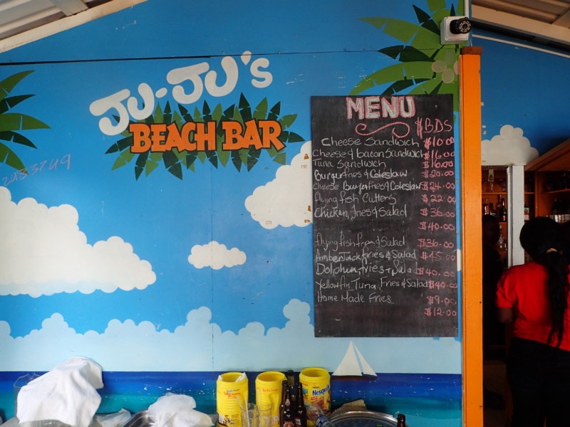 the orange and blue sign for Juju's restaurant including chalk board menu 
