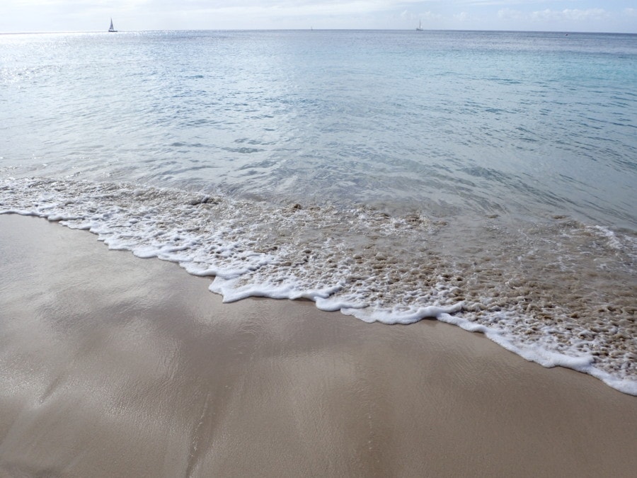 picture of Barbados with waves rolling on soft beach