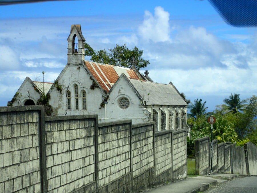 fence in front of white church with orange roof