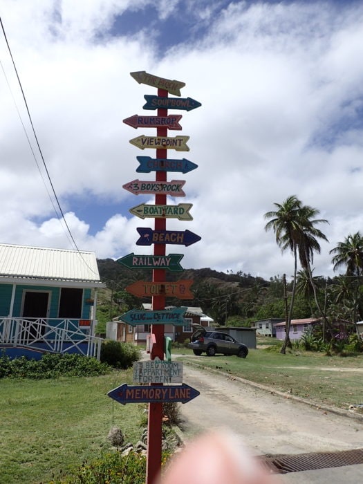 picture of Barbados tall sign at Bathsheba with colourful arrow pointing directions