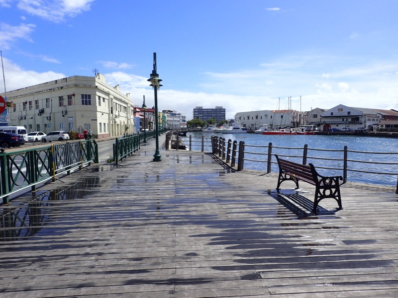 bridgetown boardwalk with wooden benches along water side is great Barbados Attraction