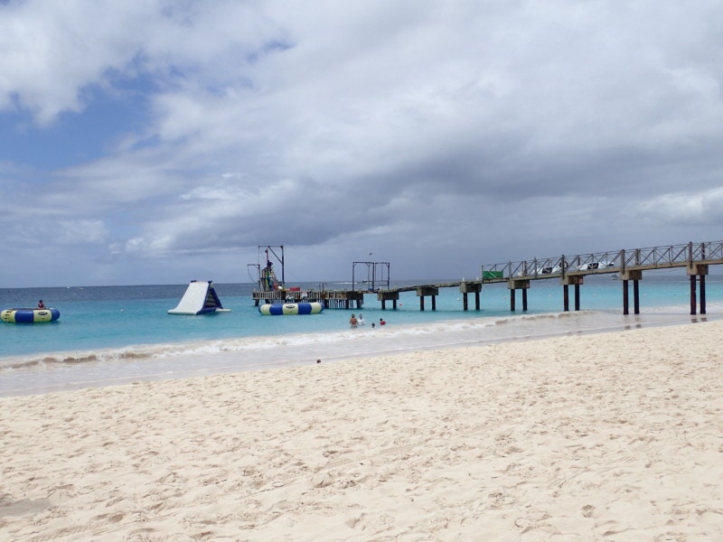 beach and water photo showing water trampoline and iceberg as well as wharf is Barbados attraction Bridgetown