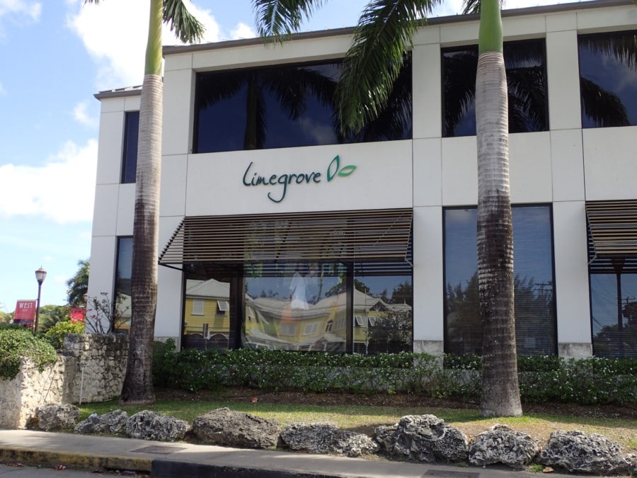 Outside picture of limegrove mall with green logo on white building