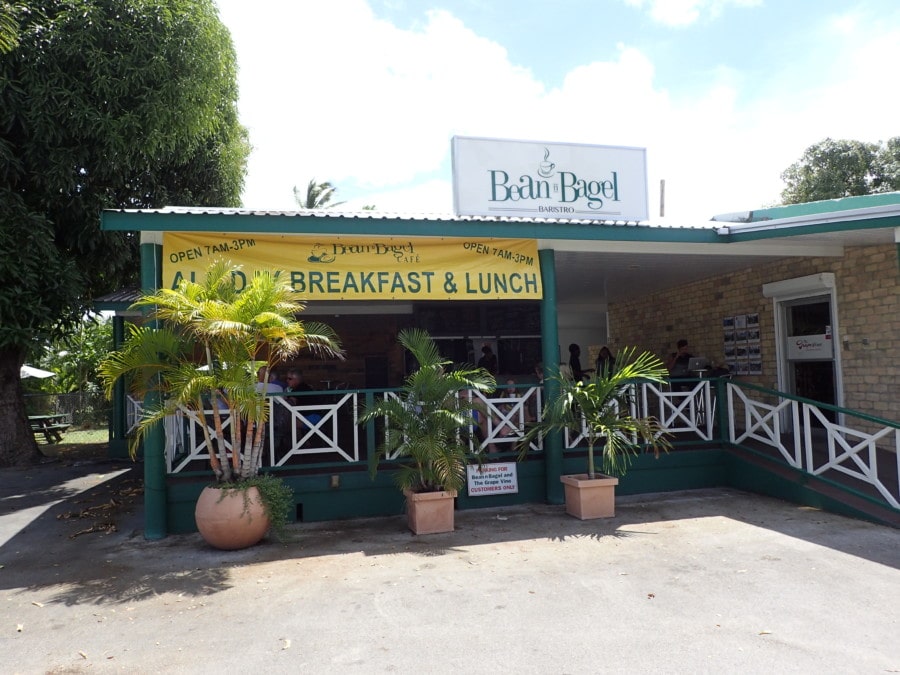 L shaped building with yellow banner stating Bean n Bagel Barbados