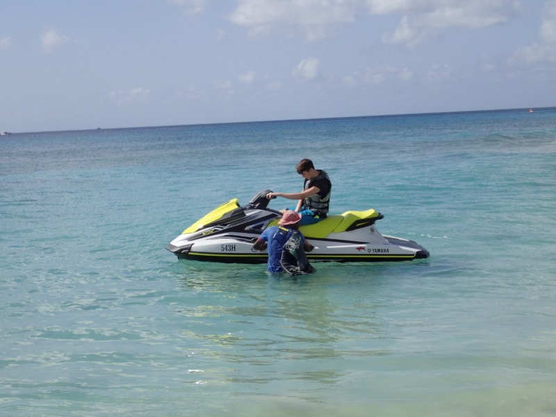 my boys being taught by two local men how to use the jet ski Barbados attractions