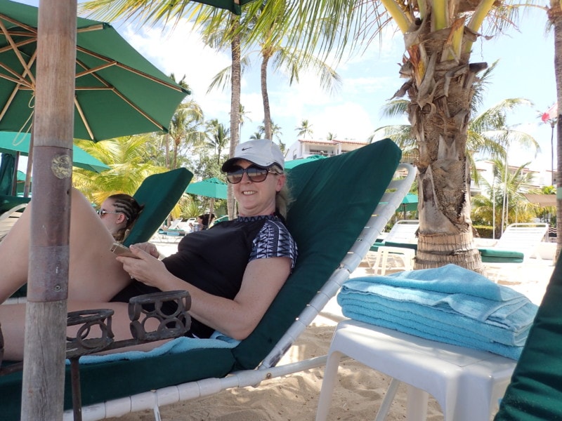 Barbados Attraction of me relaxing on a beach with sunglasses and my phone
