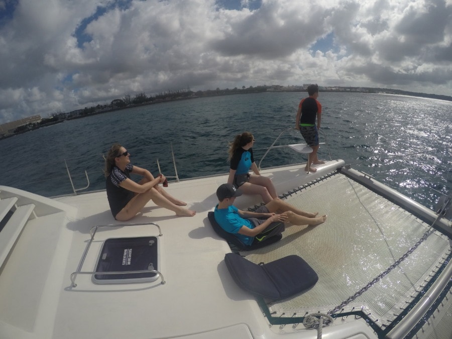me and the three kids sitting on the front of the catamaran
