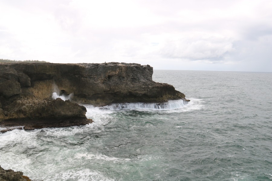 high cliffs with crashing waves and water rolling off cliffs