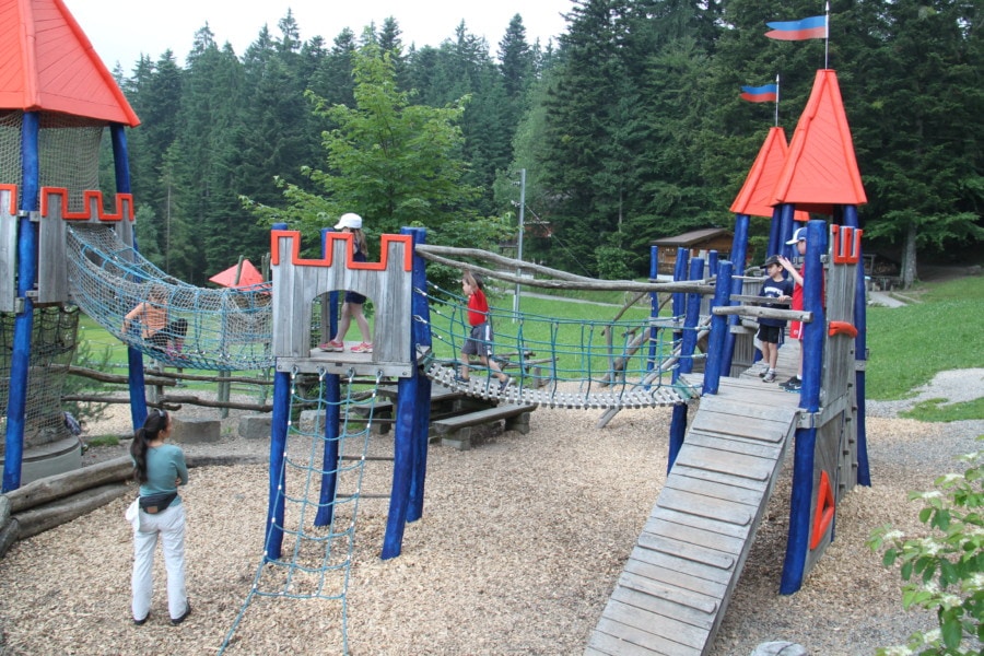 playground with ropes between landing pads with orange peaked roofs