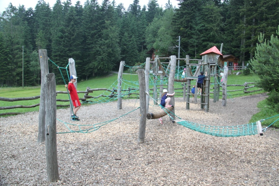 playground with ropes between landing pads with orange peaked roofs 
