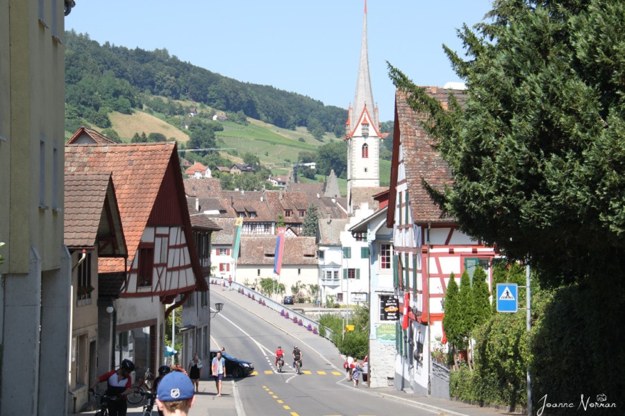 road with traditional swiss houses on each side and church at end of the road