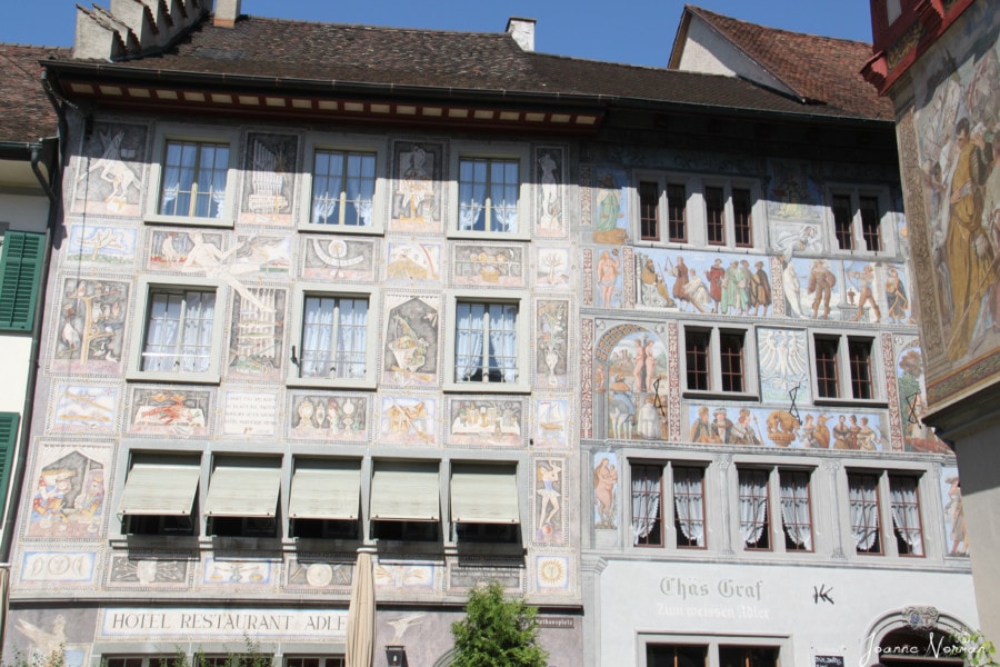 Multi story house with beautiful painted images above Hotel Restaurant Adler in Stein am Rhine old town