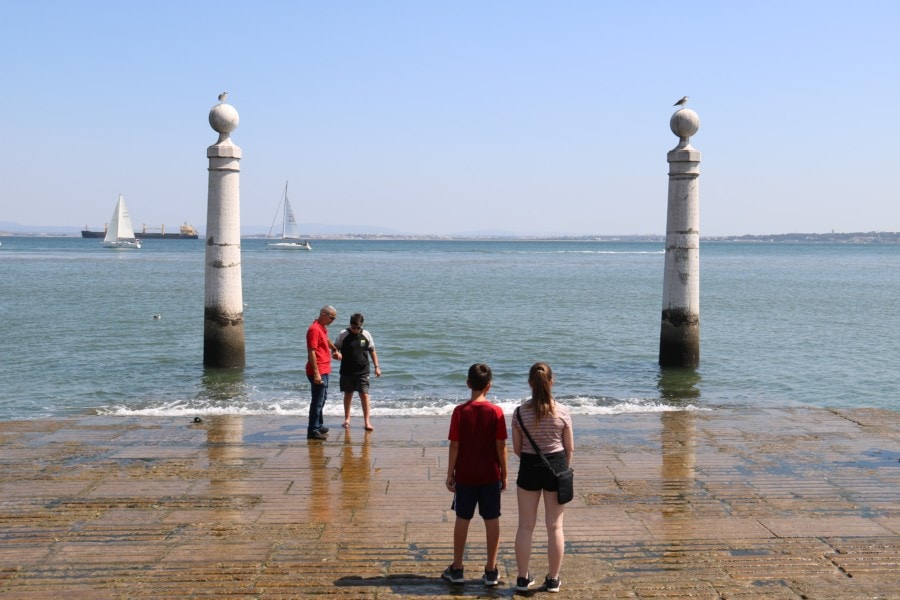two kids looking at pillars in water at waterfront