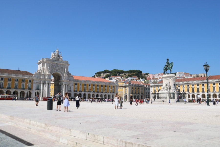 large square with yellow buildings surrounding and large arch is great Lisbon activities