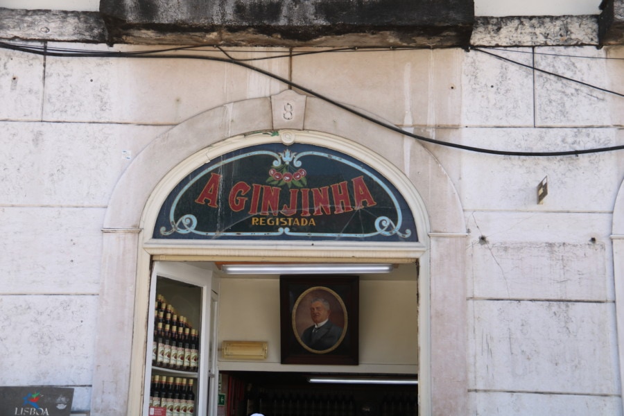 stone storefront with arched window over door stating A Ginjinja in red