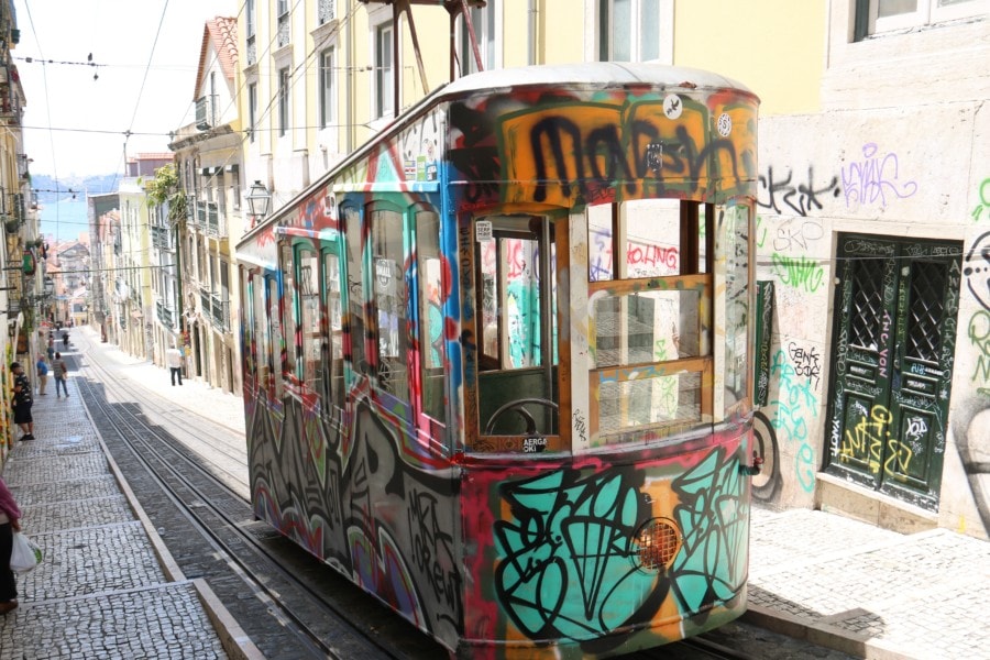 train like funicular filled with grafitti ascensor da bica