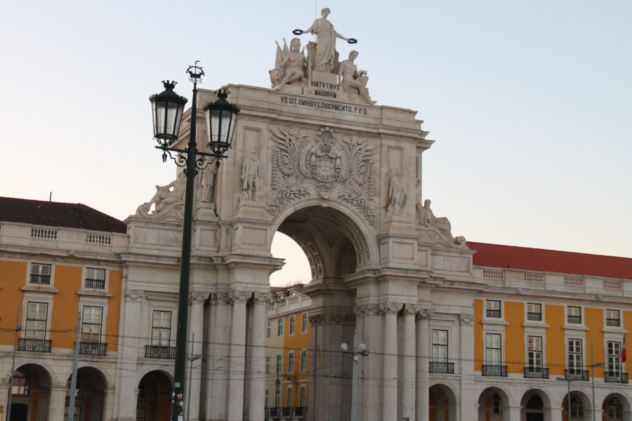 large stone archway with statues on top