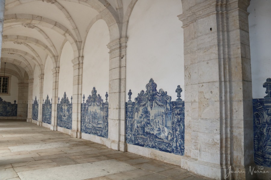 Hallway with blue tiles along wall