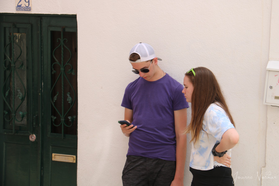 Two teens looking at smart phone