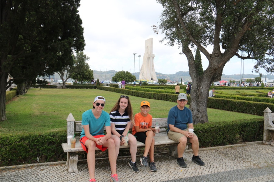 kids in park with John and Monument of Discoveries behind